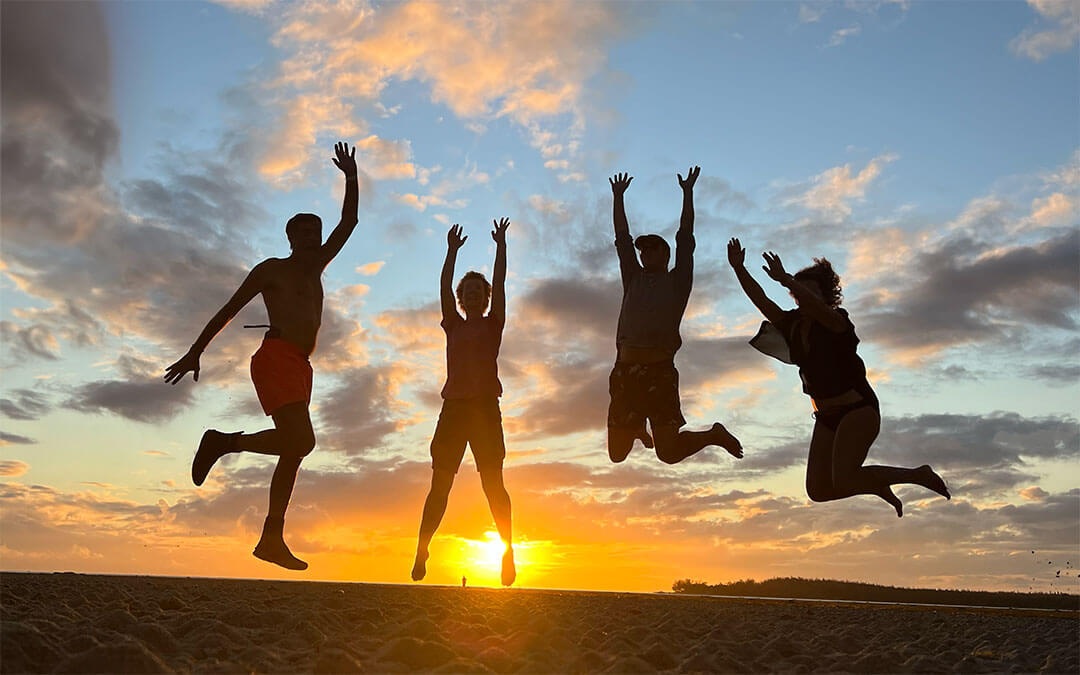 People at sunset jumping