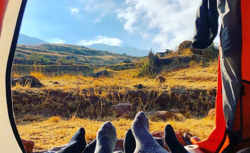 View from inside a tent onto a golden mountain valley in La Paz, Bolivia