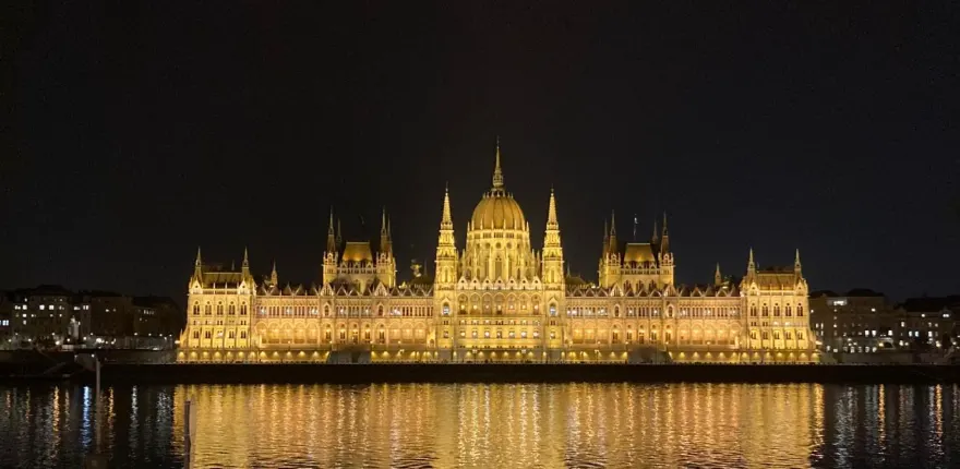 Floodlit parliament building reflected in the Danube at night in Budapest, Hungary
